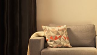 "Cosy living room with modern LED table lamp, illuminating grey loveseat and creating warm ambiance for home relaxation."